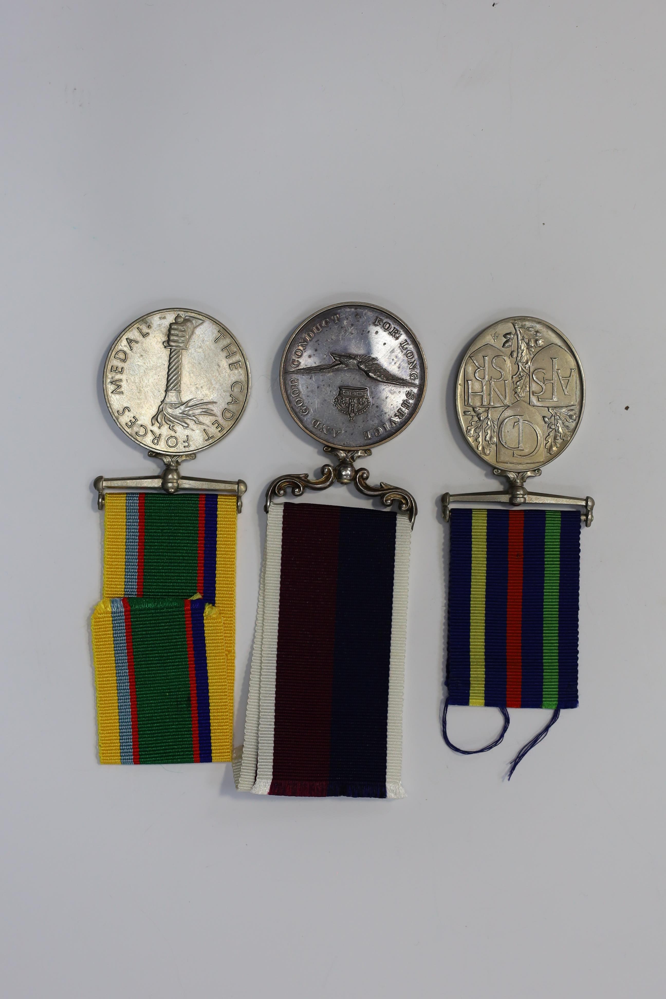 Three assorted service medals; GVI Cadet Forces medal to ACT. FG. Off. A. Liddell R.A.F.V.R (T); ERII Civil Defence Long Service medal unnamed; ERII RAFLSGC to E2418184 Cpl G R B Lowe RAF. Condition - fair to good.